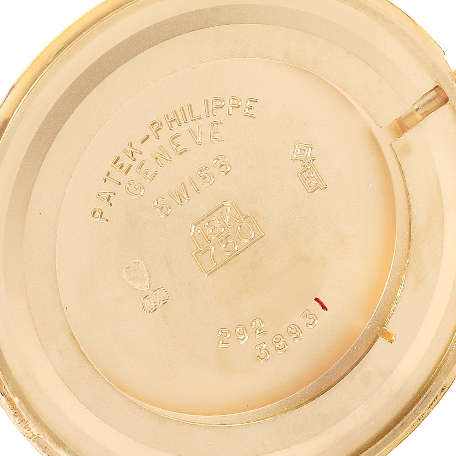 This image shows the inside of the case back of a Patek Philippe Calatrava 3893J Men's Yellow Gold Beige Dial 3893J Men's Yellow Gold Beige Dial watch, displaying the brand engraving and material information.