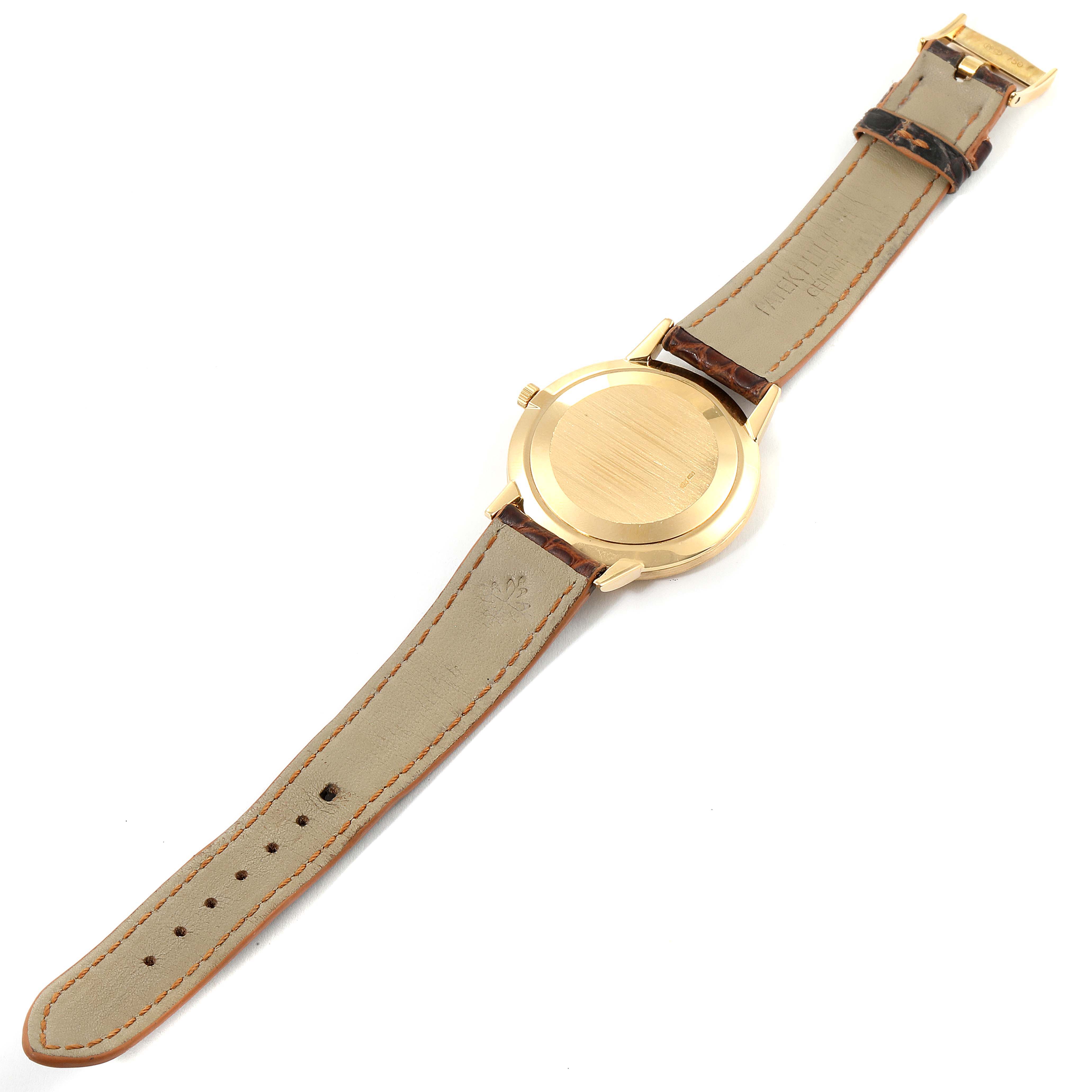 The image shows the back and strap of a Patek Philippe Calatrava 3893J Men's Yellow Gold Beige Dial 3893J Men's Yellow Gold Beige Dial watch, positioned flat.