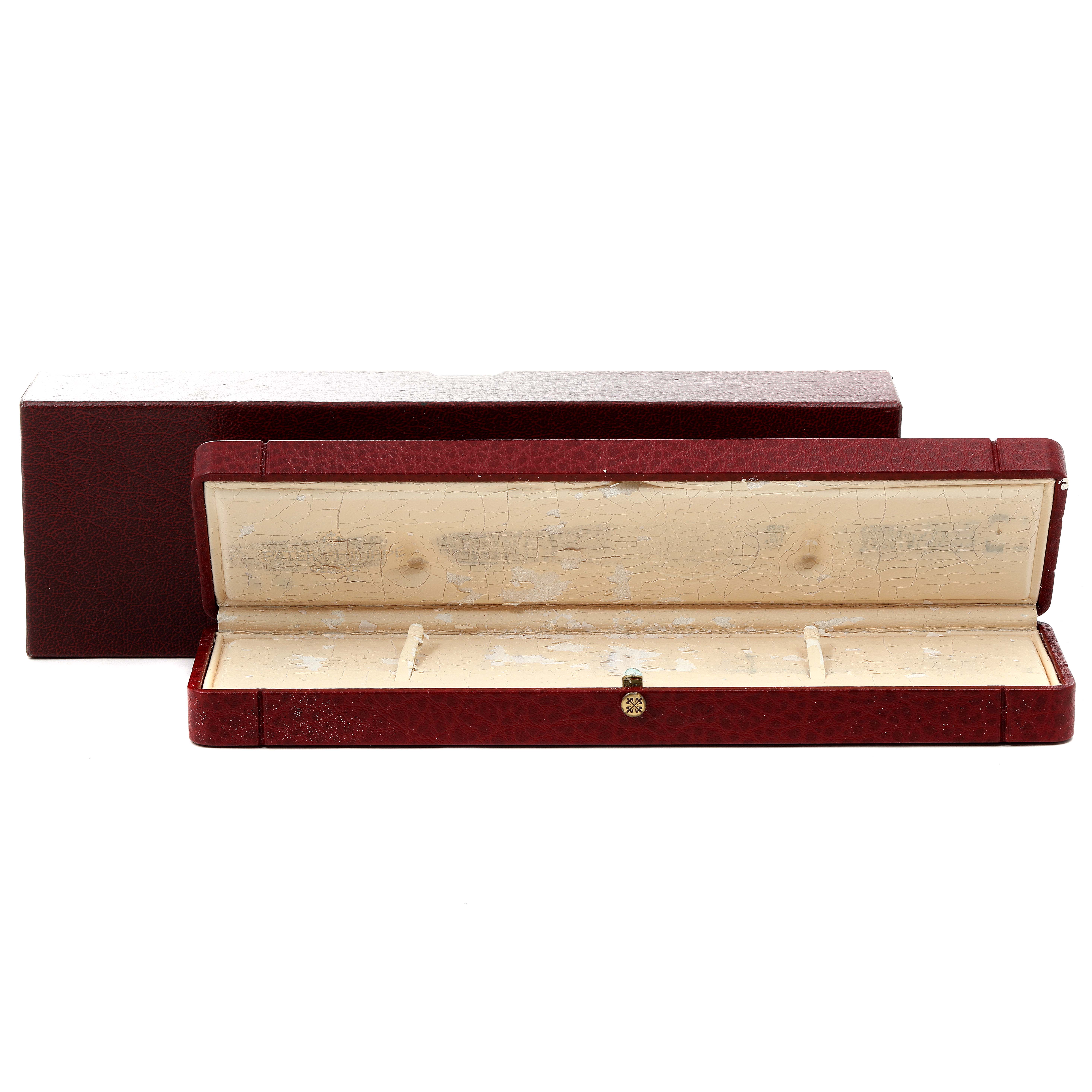 The image shows an open Patek Philippe Calatrava 5015 Men's Rose Gold White Dial 5015 Men's Rose Gold White Dial watch box with a red exterior and a worn cream interior.