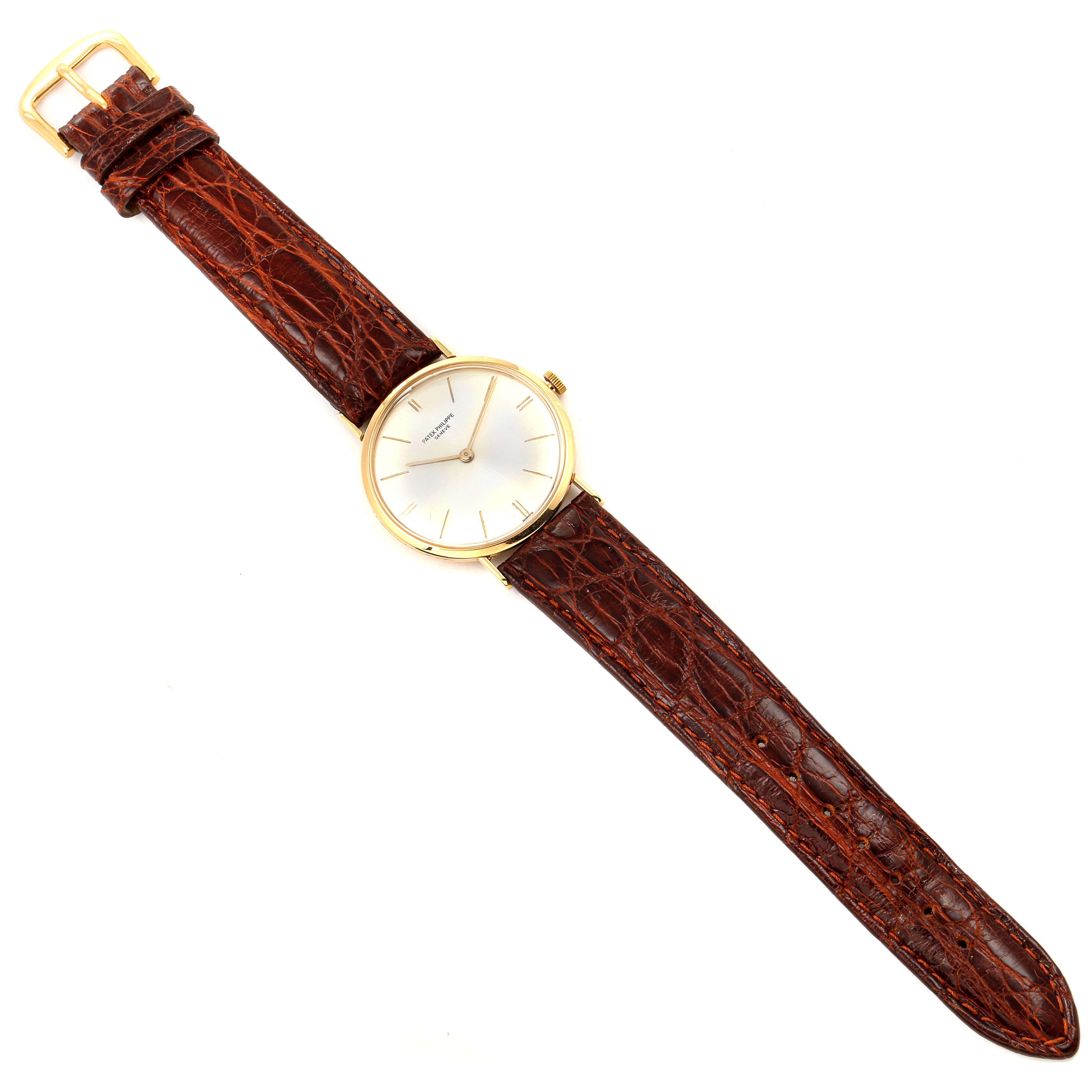 The image shows a top-down view of a Vintage Patek Philippe watch with a brown leather strap and a gold case.