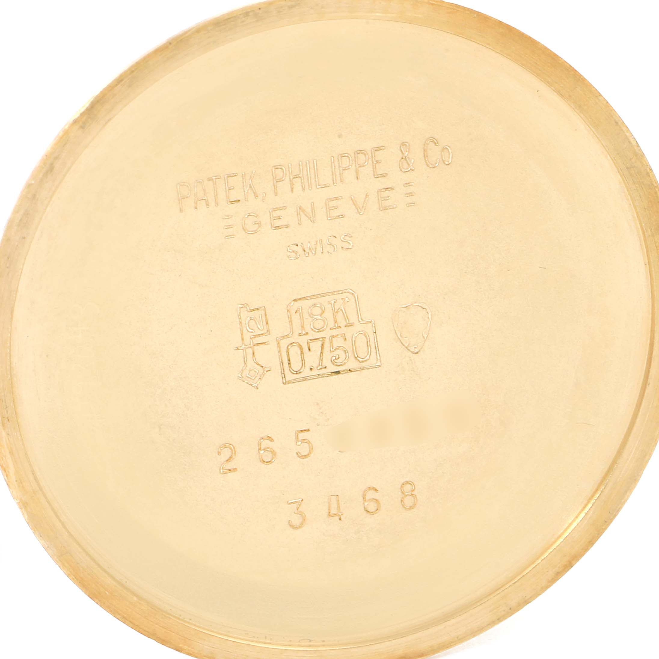 This image shows the inner case back of a Vintage Patek Philippe watch, stamped with hallmark details and the brand's information.