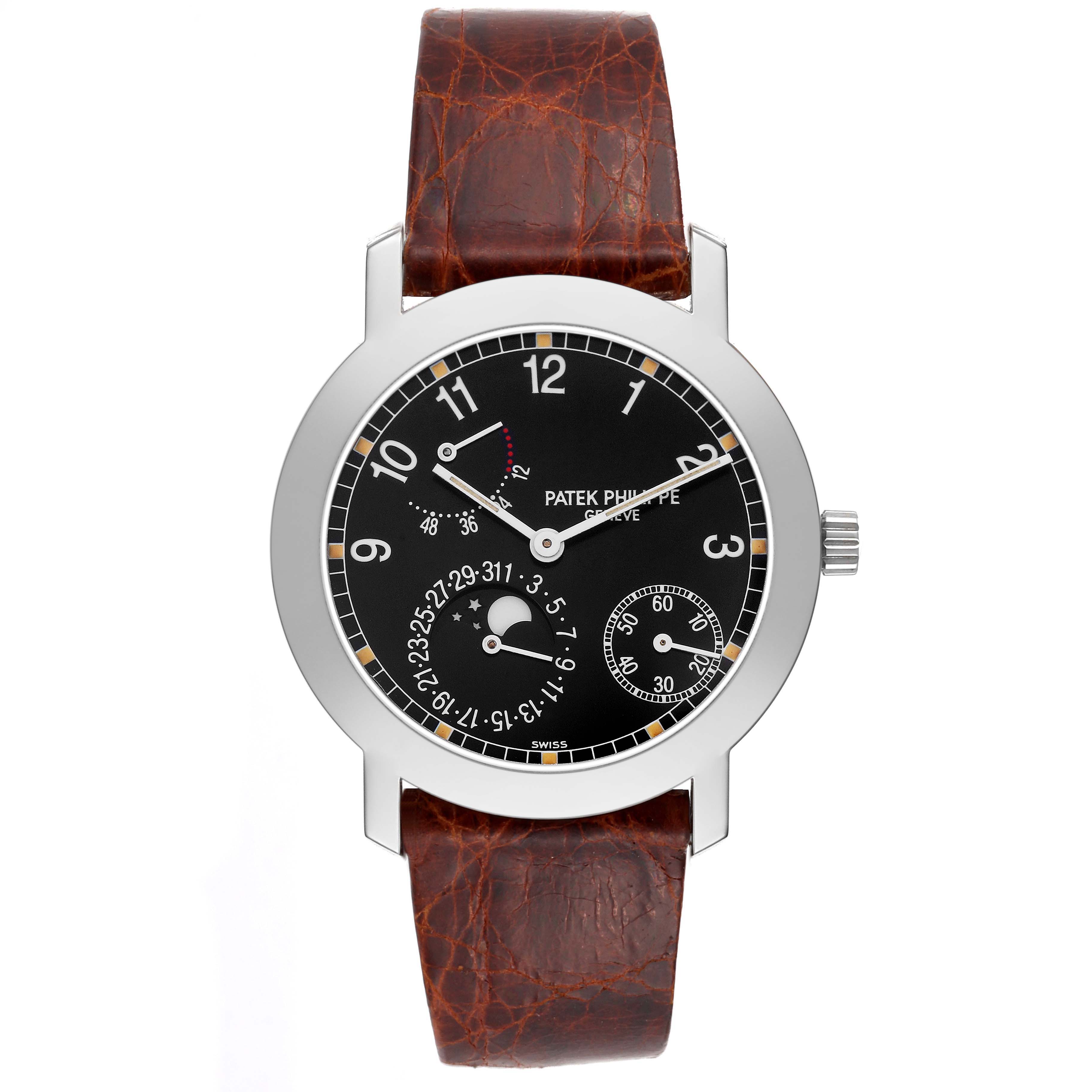 The Patek Philippe Complications 5055G-001 Mens White Gold Black Dial watch is shown from a front angle, displaying the dial, hands, date indicators, and brown leather strap.