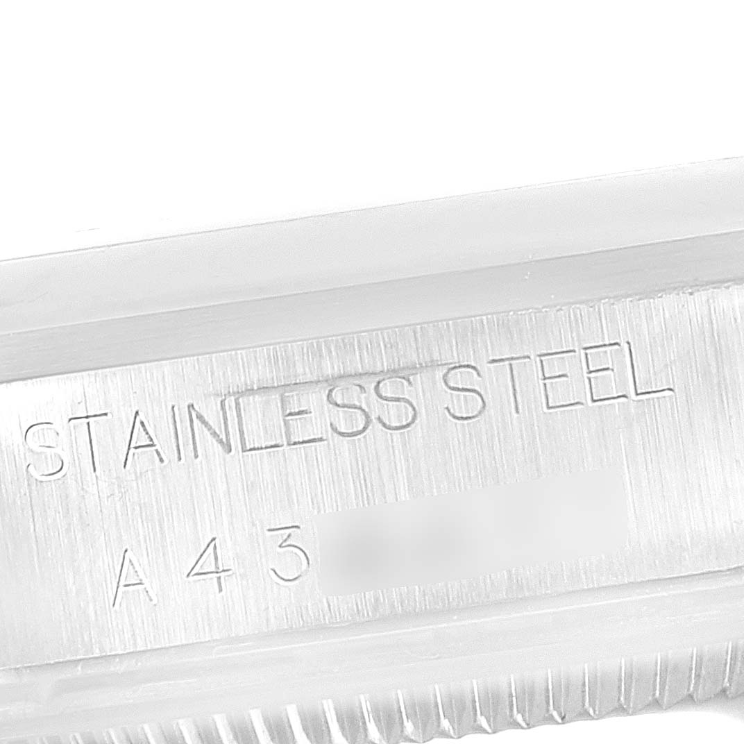 This close-up image of a Rolex Air-King 14000M Men's Stainless Steel Blue Dial 14000M Men's Stainless Steel Blue Dial watch shows the stamped "STAINLESS STEEL" engraving.