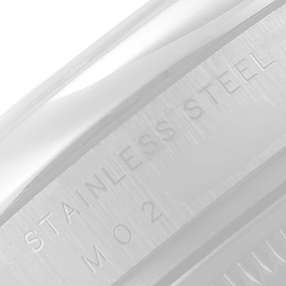 The image shows a close-up of the Rolex Air-King 114200 Men's Stainless Steel Silver Dial 114200 Men's Stainless Steel Silver Dial watch case, highlighting the "STAINLESS STEEL" engraving.