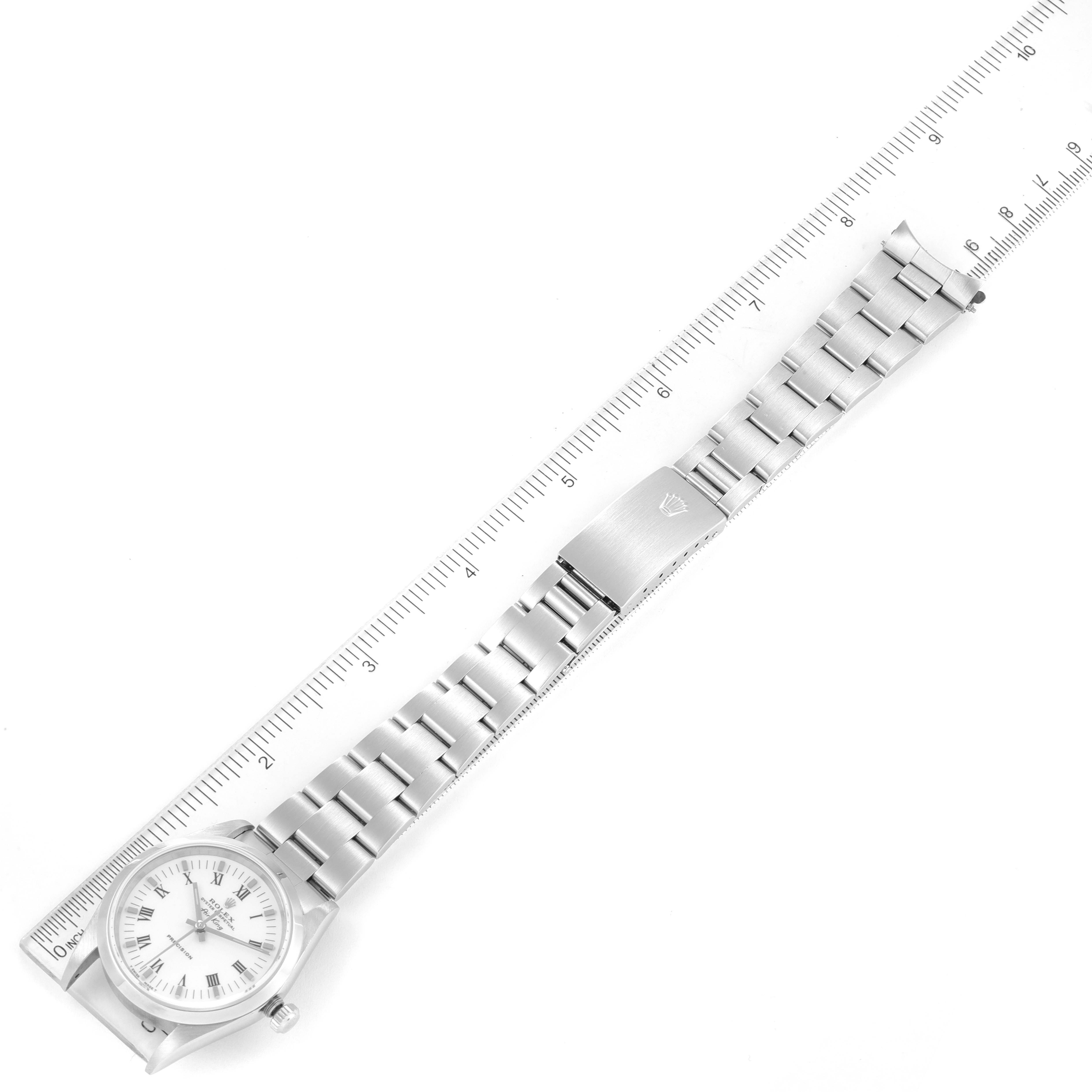 The image shows a top-down view of the Rolex Air-King 14000 Men's Stainless Steel White Dial 14000 Men's Stainless Steel White Dial watch, highlighting its full length, bracelet, and clasp with a ruler for scale.