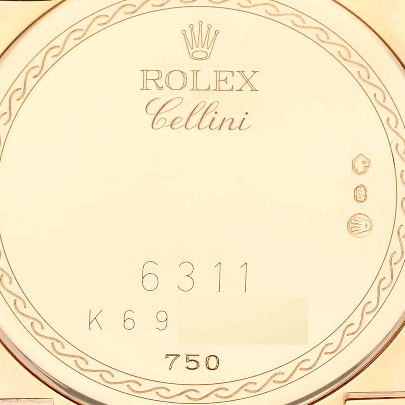 The image shows the back of a Rolex Cellini 6311 Women's Yellow Gold Mother of Pearl Dial 6311 Women's Yellow Gold Mother of Pearl Dial watch, featuring the brand name, model name, and some engraved details.