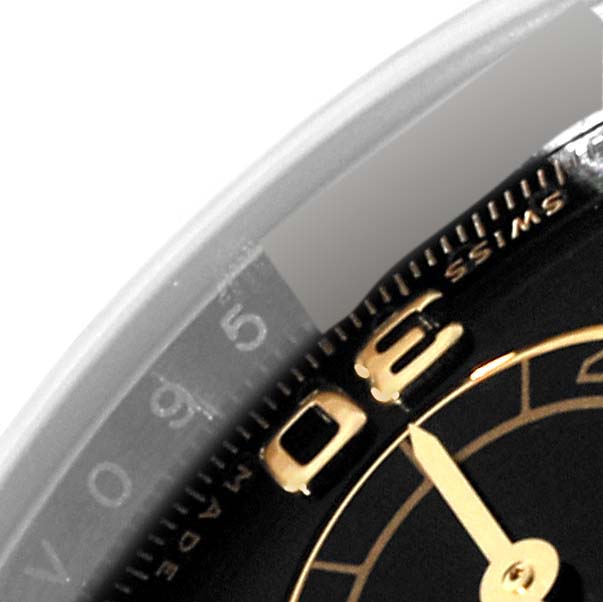 The image shows a close-up of the dial, bezel, and part of the minute hand of a Rolex Daytona 116503 Men
s Steel and Gold (two tone) Black Dial 116503 Men
s Steel and Gold (two tone) Black Dial watch.