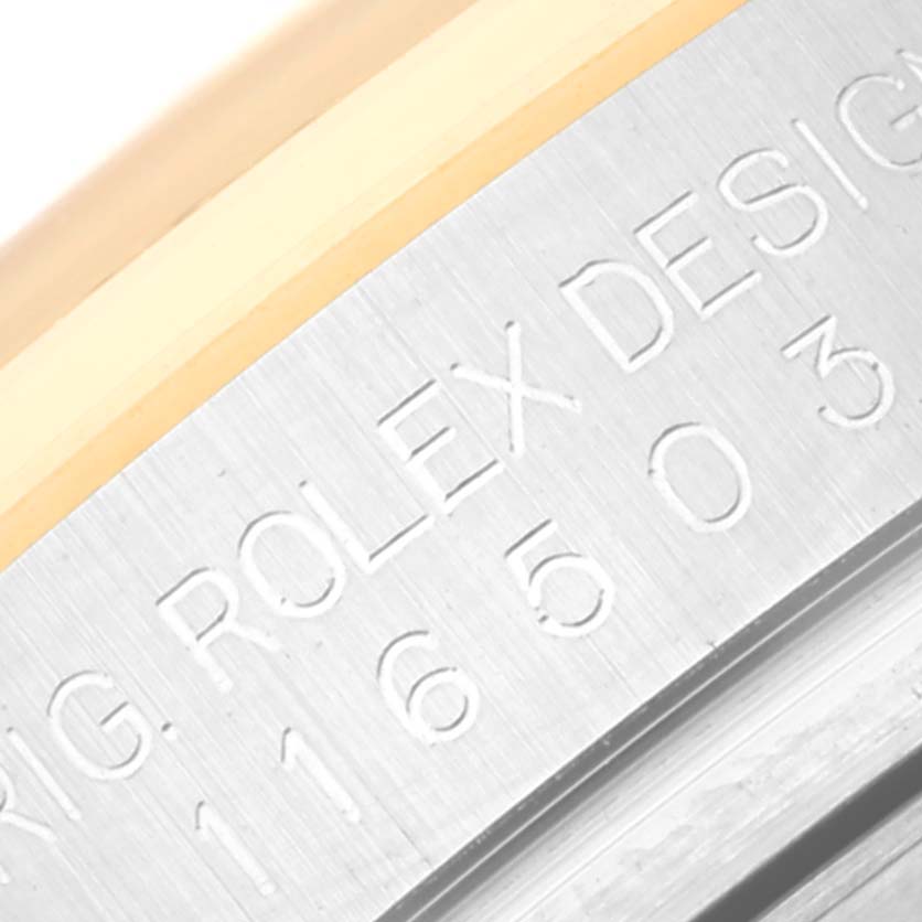 The image shows a close-up of the engraved model details on the side of a Rolex Daytona 116503 Men
s Steel and Gold (two tone) Black Dial 116503 Men
s Steel and Gold (two tone) Black Dial watch case.