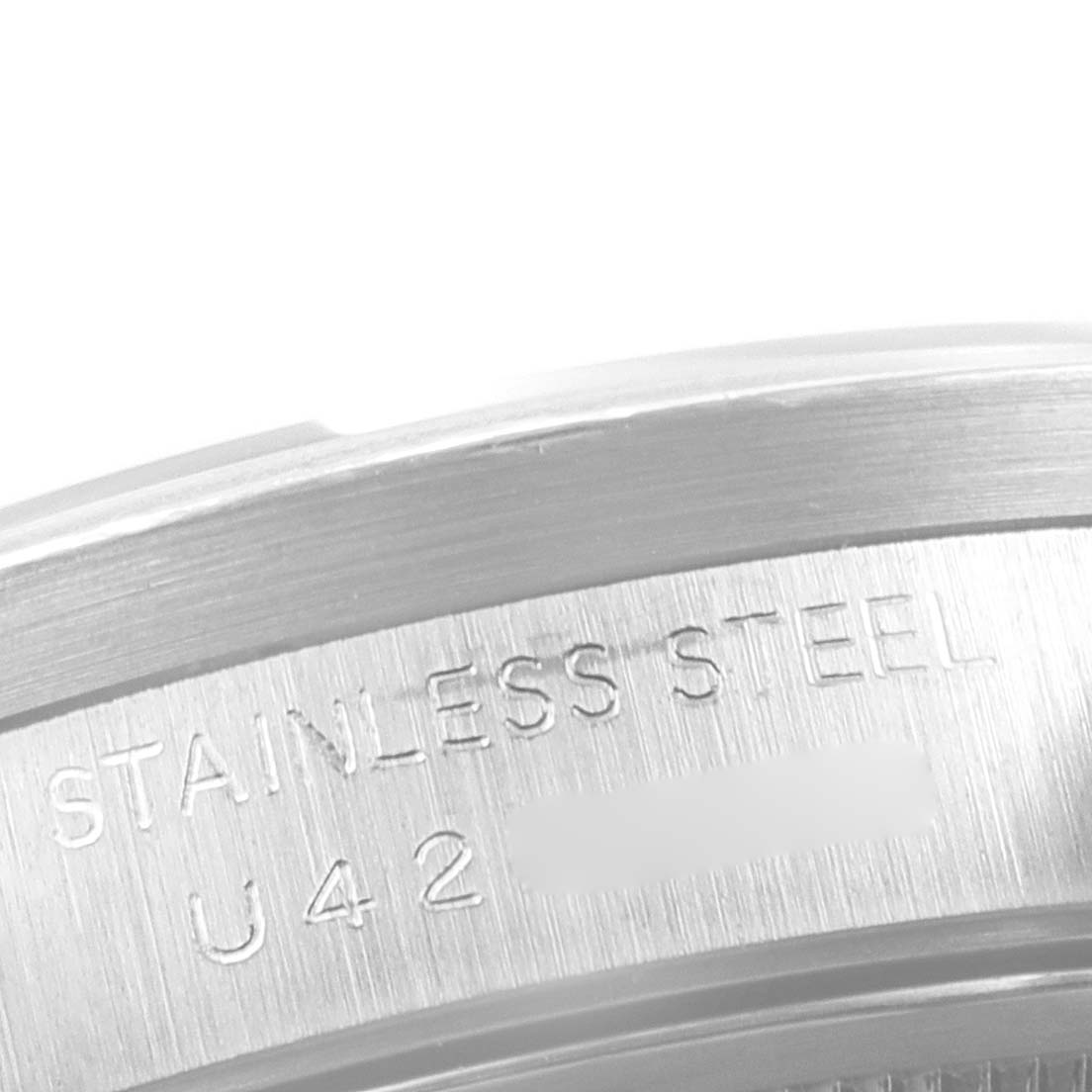 This image shows a close-up of the stainless steel case back of a Rolex Air-King 15210 Men's Stainless Steel Blue Dial 15210 Men's Stainless Steel Blue Dial watch, featuring engraved text.