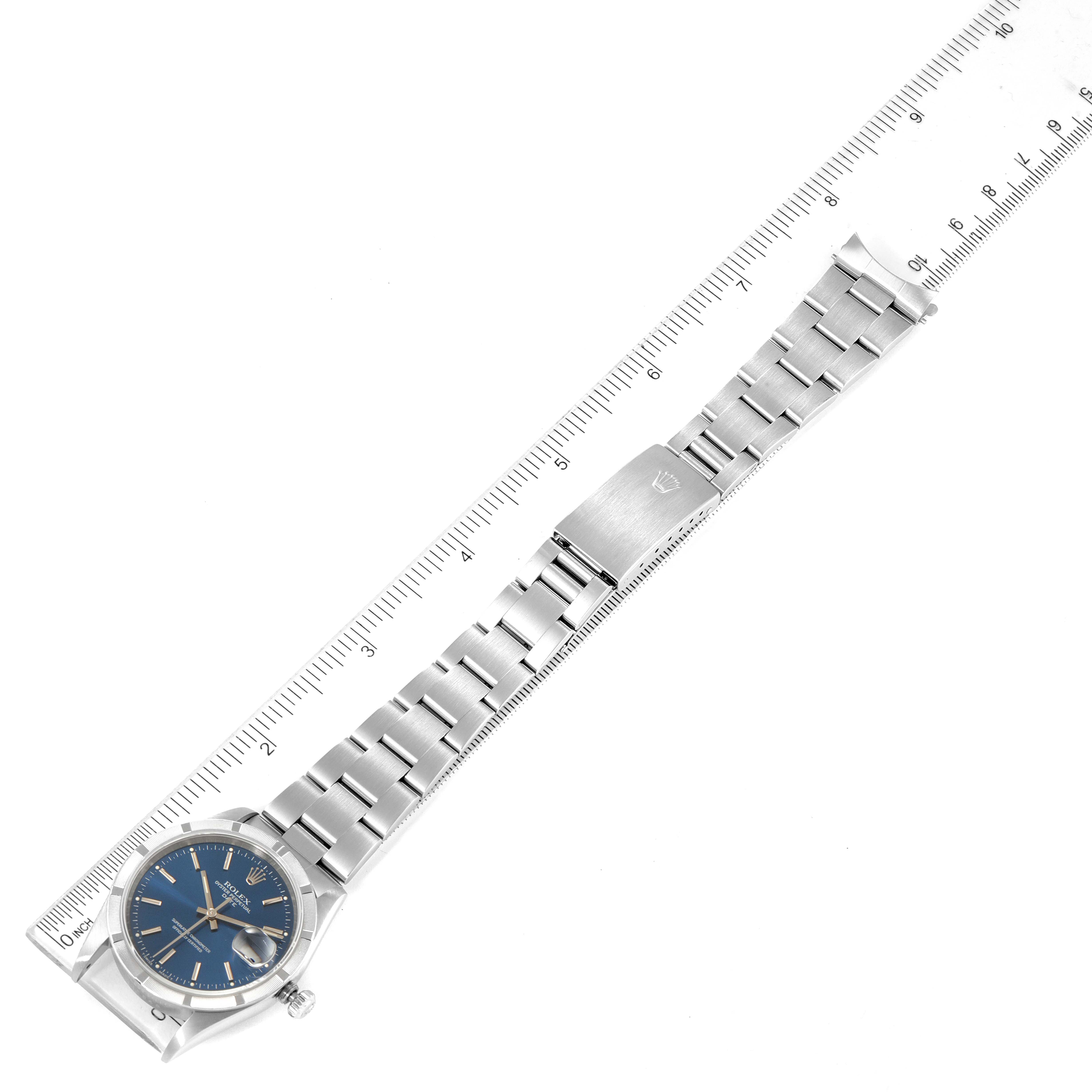 The image shows a top view of the Rolex Air-King 15210 Men's Stainless Steel Blue Dial 15210 Men's Stainless Steel Blue Dial watch, including the face, bracelet, clasp, and a ruler for measurement.