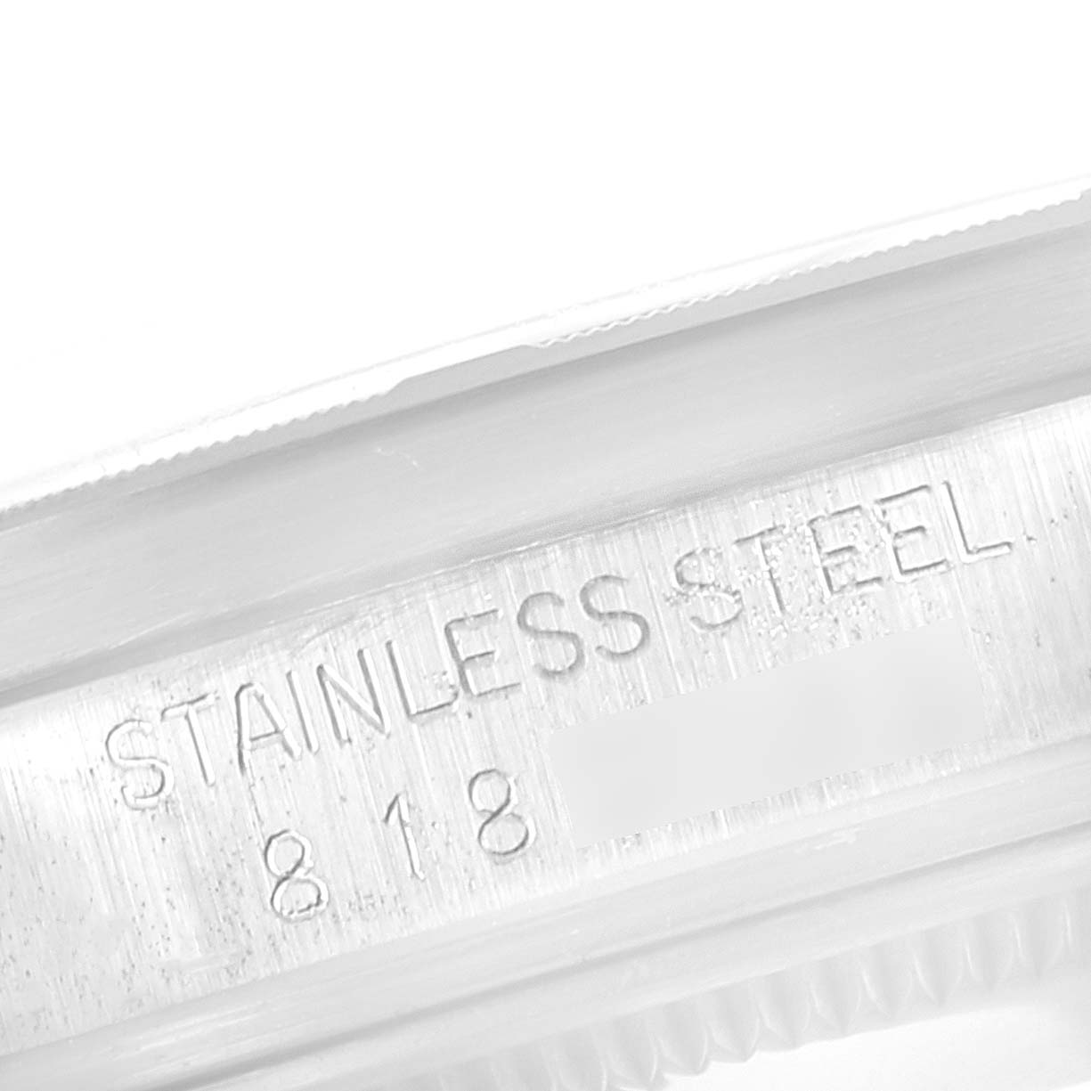This image shows a close-up of the engraved stainless steel marking on the side of a Rolex Vintage Collection 15010 Men's Stainless Steel Silver Dial 15010 Men's Stainless Steel Silver Dial watch case.