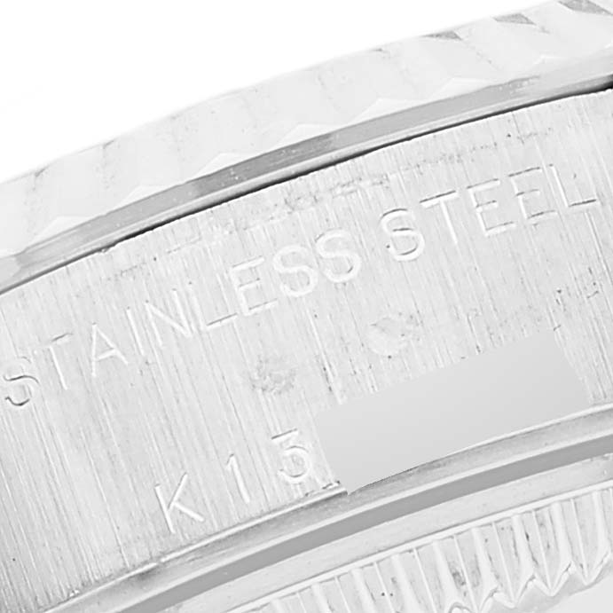 This image shows a close-up of the stainless steel back of a Rolex Datejust 79174 Women's Stainless Steel Silver Dial 79174 Women's Stainless Steel Silver Dial watch, highlighting the bezel's edge and part of the engraved text.