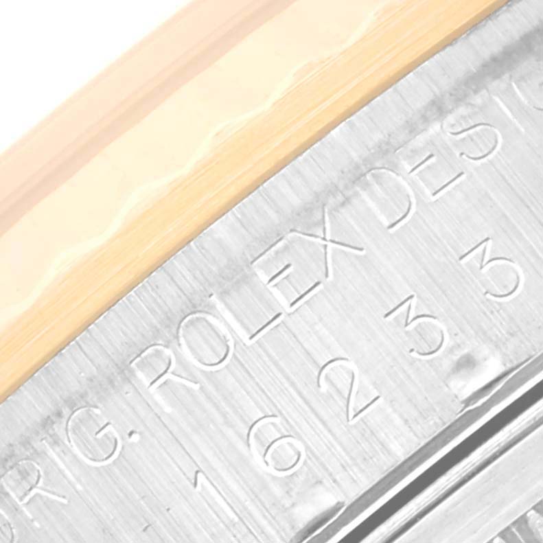 Close-up angle showing the engraved model details on the metal case of the Rolex Datejust 16233 Men's Steel and Gold (two tone) Silver Dial 16233 Men's Steel and Gold (two tone) Silver Dial watch.