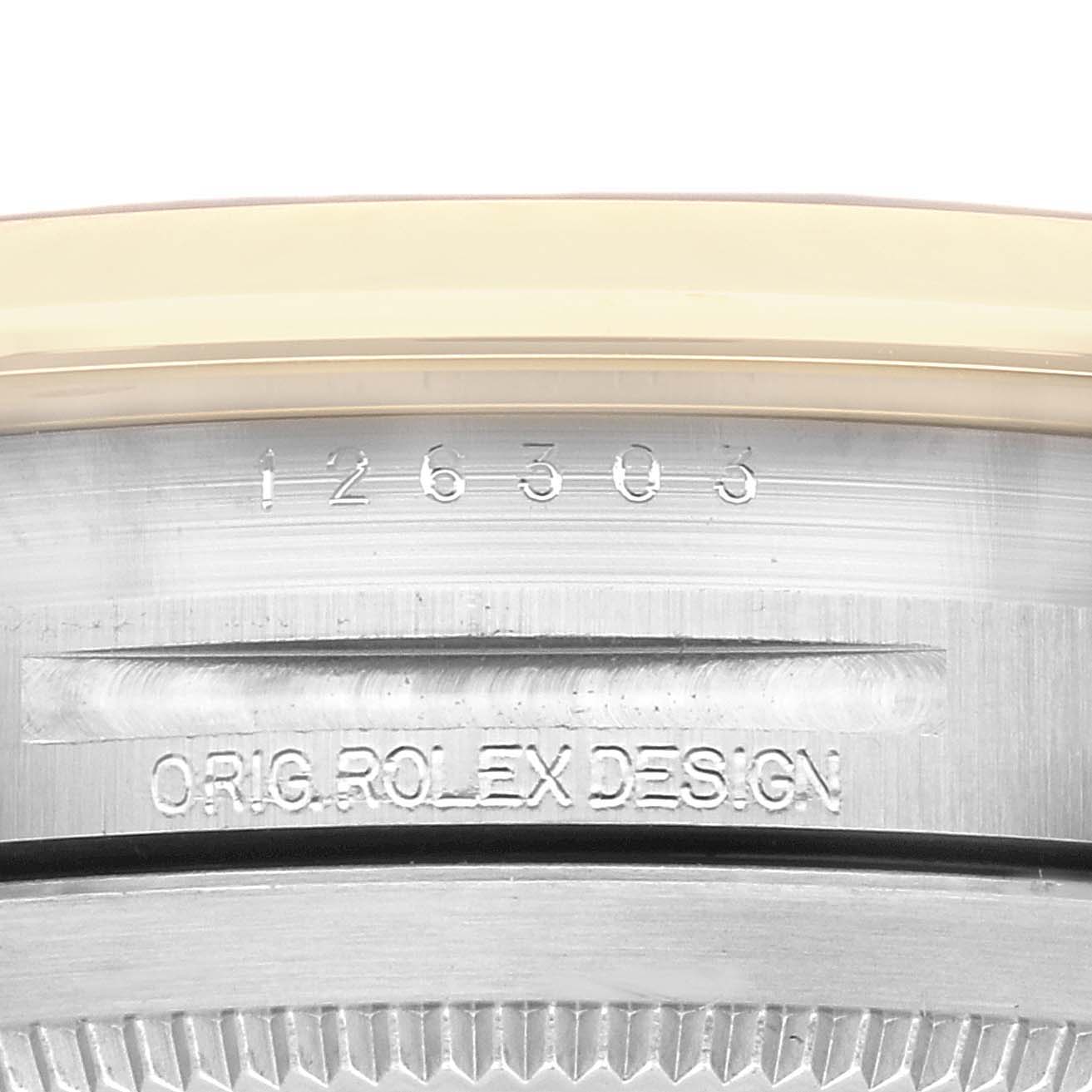 This image shows the model and serial numbers inscribed on the case of a Rolex Datejust 41 126303 Men's Steel and Gold (two tone) Black Dial 126303 Men's Steel and Gold (two tone) Black Dial watch, partially viewed from the back.