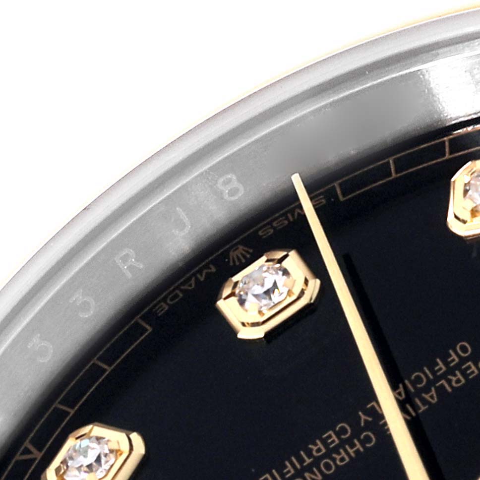 This image shows a close-up of the dial and part of the bezel of the Rolex Datejust 41 126303 Men's Steel and Gold (two tone) Black Dial 126303 Men's Steel and Gold (two tone) Black Dial watch, highlighting the diamond hour markers.
