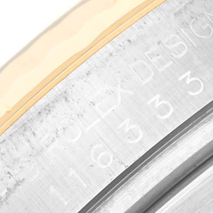 This image shows an angled close-up of the engraving on the steel case of a Rolex Datejust 41 116333 Men's Steel and Gold (two tone) Grey Dial 116333 Men's Steel and Gold (two tone) Grey Dial watch.