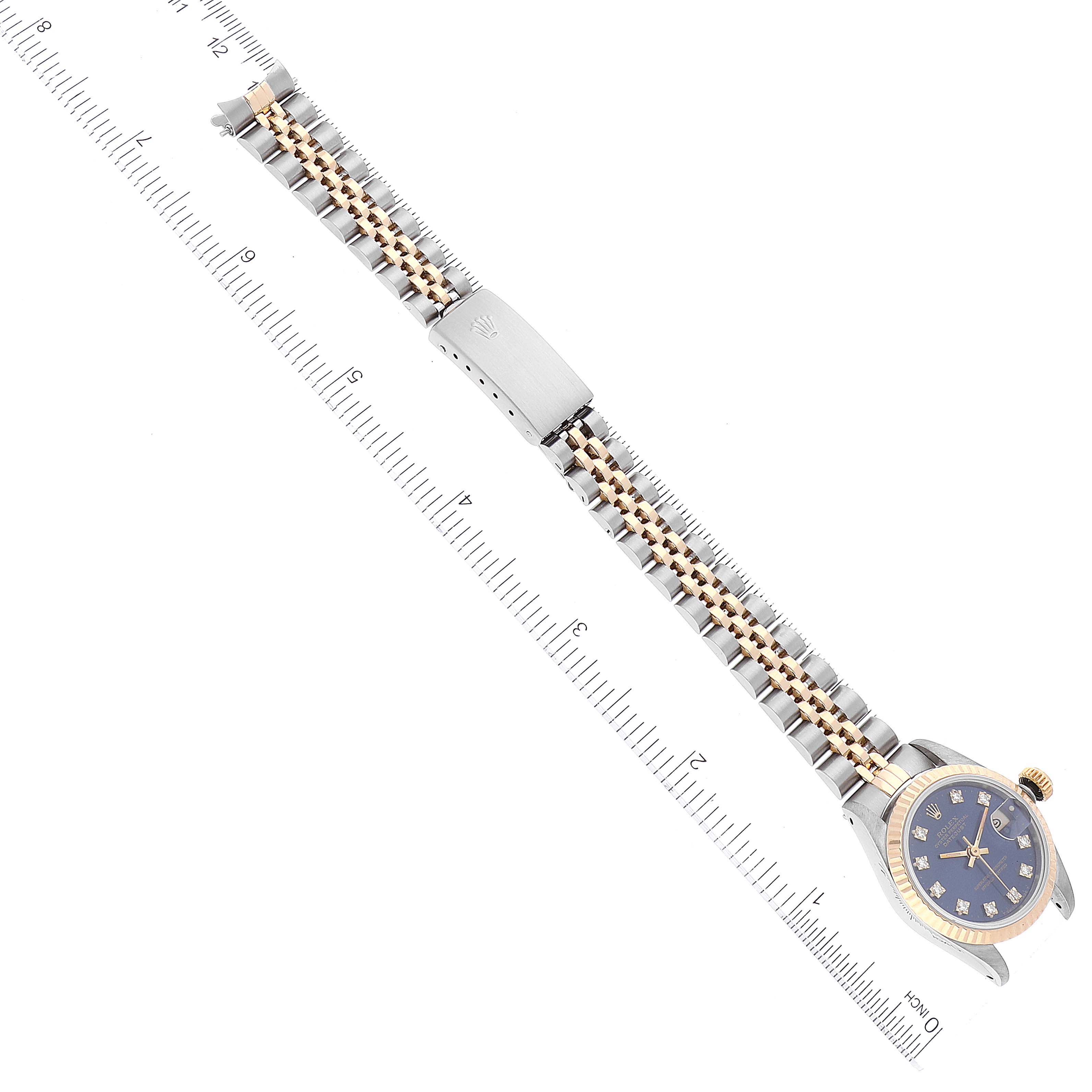 The image shows a Rolex Datejust 69173 Women's Steel and Gold (two tone) Blue Dial 69173 Women's Steel and Gold (two tone) Blue Dial watch laid flat, displaying its face, bracelet, and clasp alongside a ruler for scale.