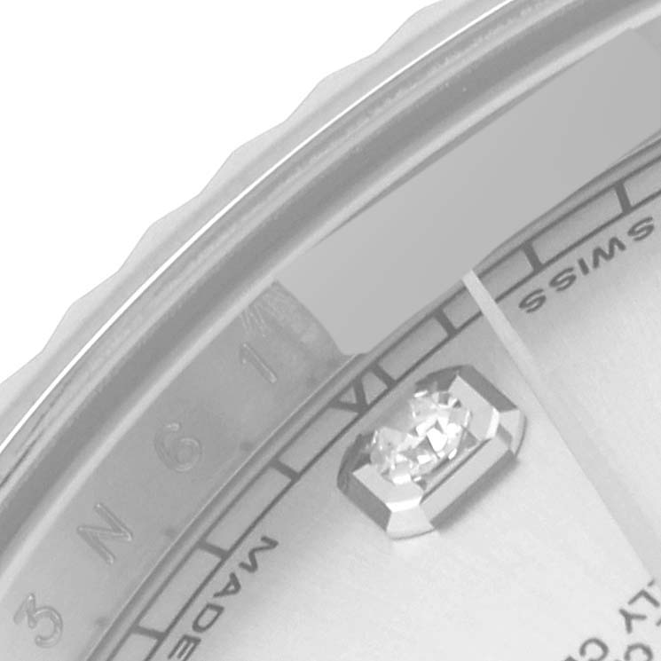 This close-up image of the Rolex Datejust 41 116334 Men
s Stainless Steel Silver Dial 116334 Men
s Stainless Steel Silver Dial watch shows the bezel, part of the dial, and a diamond hour marker.