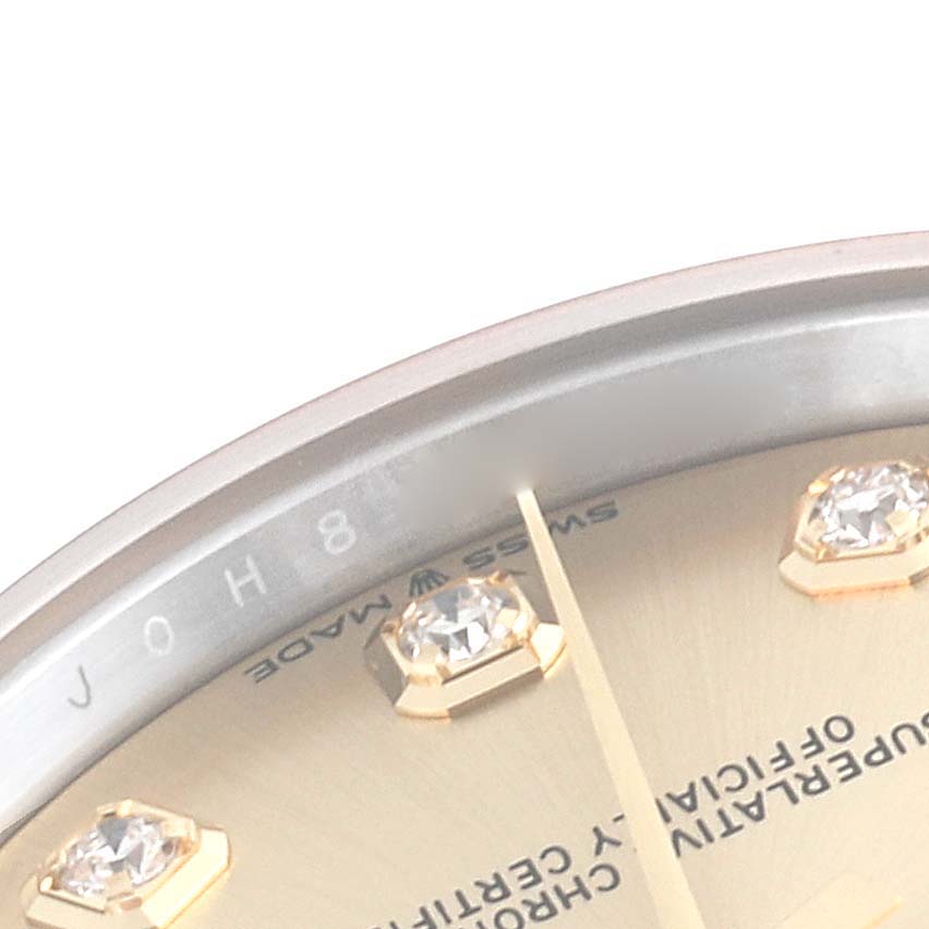 The image shows a close-up, angled view of the dial and bezel of a mid-size Rolex watch, highlighting its diamond hour markers.