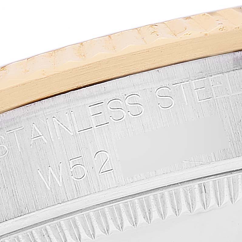 This image shows a close-up of the bezel and part of the stainless steel case with engravings on a Mid-Size Rolex watch.