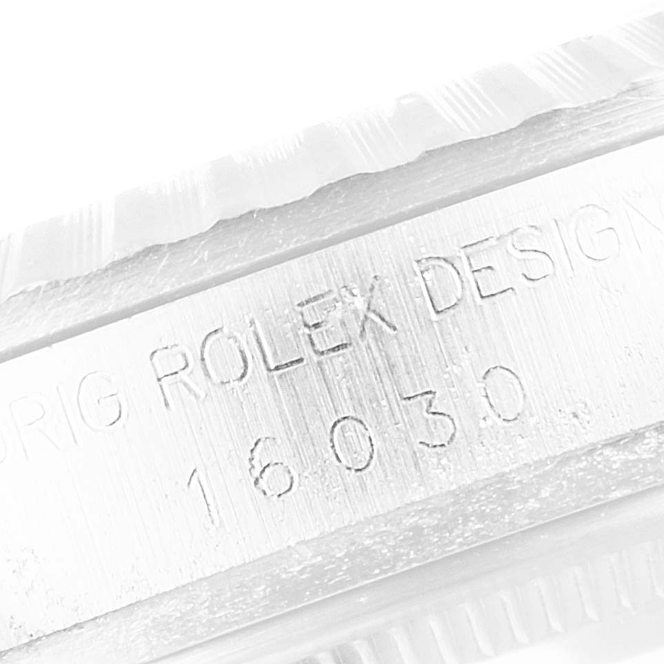 The image shows an engraved serial number on the side of a Rolex Vintage Collection 16030 Men's Stainless Steel Silver Dial 16030 Men's Stainless Steel Silver Dial model watch.