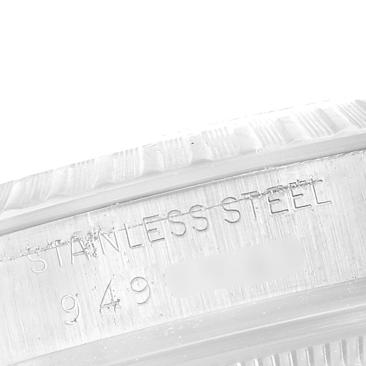 This image shows a close-up of the stainless steel case with etched markings on a Rolex Vintage Collection 16030 Men
s Stainless Steel Silver Dial 16030 Men
s Stainless Steel Silver Dial watch.