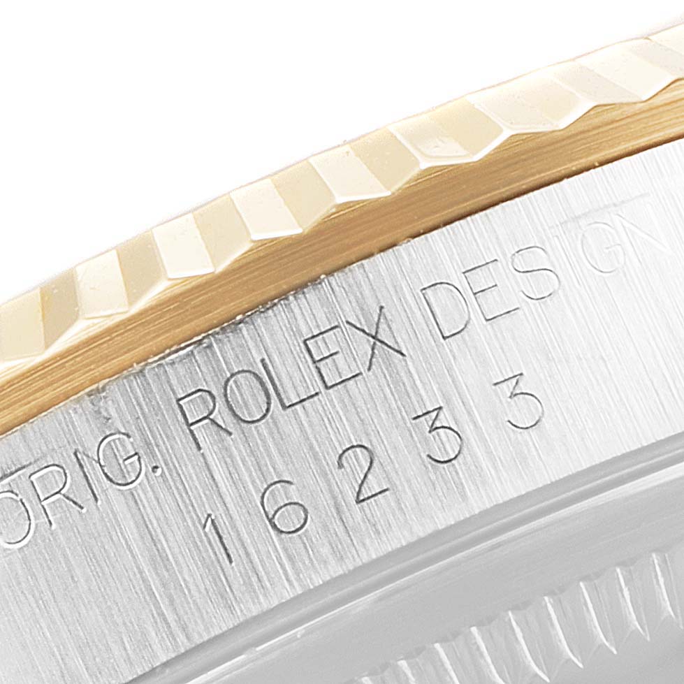 This image shows a close-up of the case side engraving with the model number on a Rolex Datejust 16233 Men's Steel and Gold (two tone) Blue Dial 16233 Men's Steel and Gold (two tone) Blue Dial.