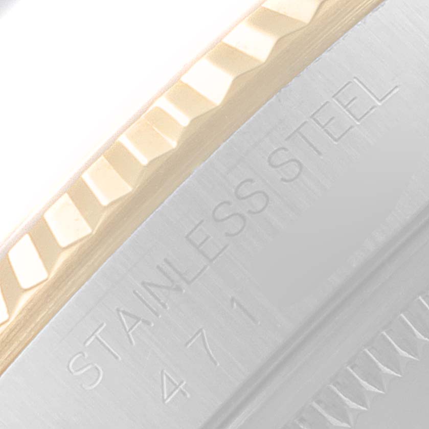 This close-up shows the fluted bezel and part of the case with "STAINLESS STEEL" engraving on the Rolex Datejust 16233 Men's Steel and Gold (two tone) Beige Dial 16233 Men's Steel and Gold (two tone) Beige Dial watch.