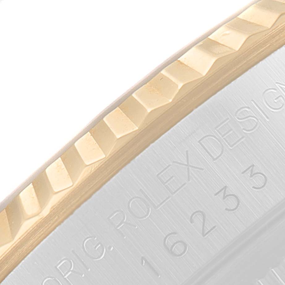 This image shows a close-up of the fluted bezel and the engraved edge of a Rolex Datejust 16233 Men's Steel and Gold (two tone) Beige Dial 16233 Men's Steel and Gold (two tone) Beige Dial watch.