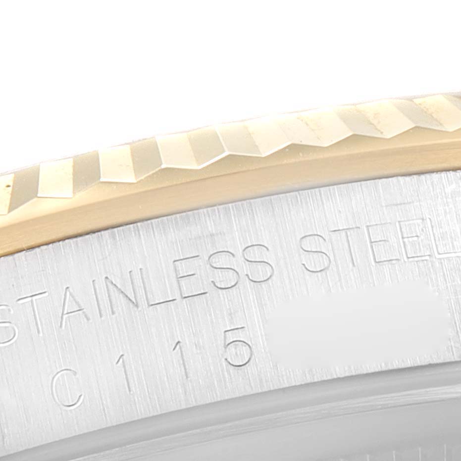 This close-up image shows the fluted bezel and part of the inscribed case of a Rolex Datejust 16233 Men's Steel and Gold (two tone) White Dial 16233 Men's Steel and Gold (two tone) White Dial watch.