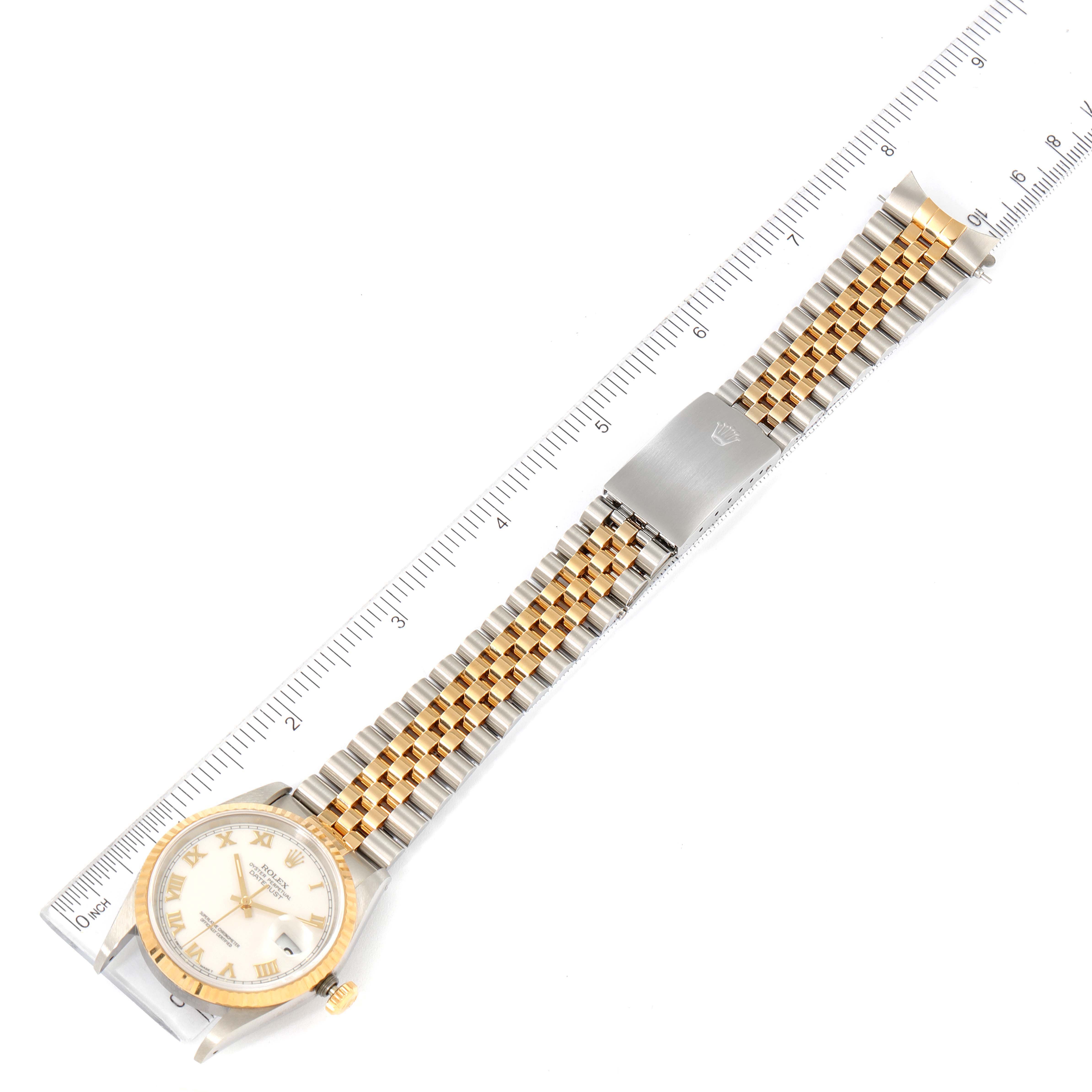 The image shows a Rolex Datejust 16233 Men's Steel and Gold (two tone) White Dial 16233 Men's Steel and Gold (two tone) White Dial watch from an overhead angle, displaying the dial, bezel, and bracelet next to a ruler.