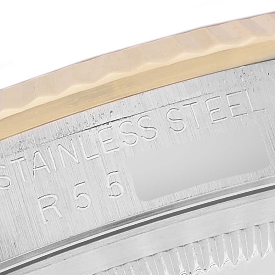 This is a close-up image of the side engraving on a Rolex Datejust 16233 Men's Steel and Gold (two tone) Champagne Dial 16233 Men's Steel and Gold (two tone) Champagne Dial watch, showing part of the bezel and case.