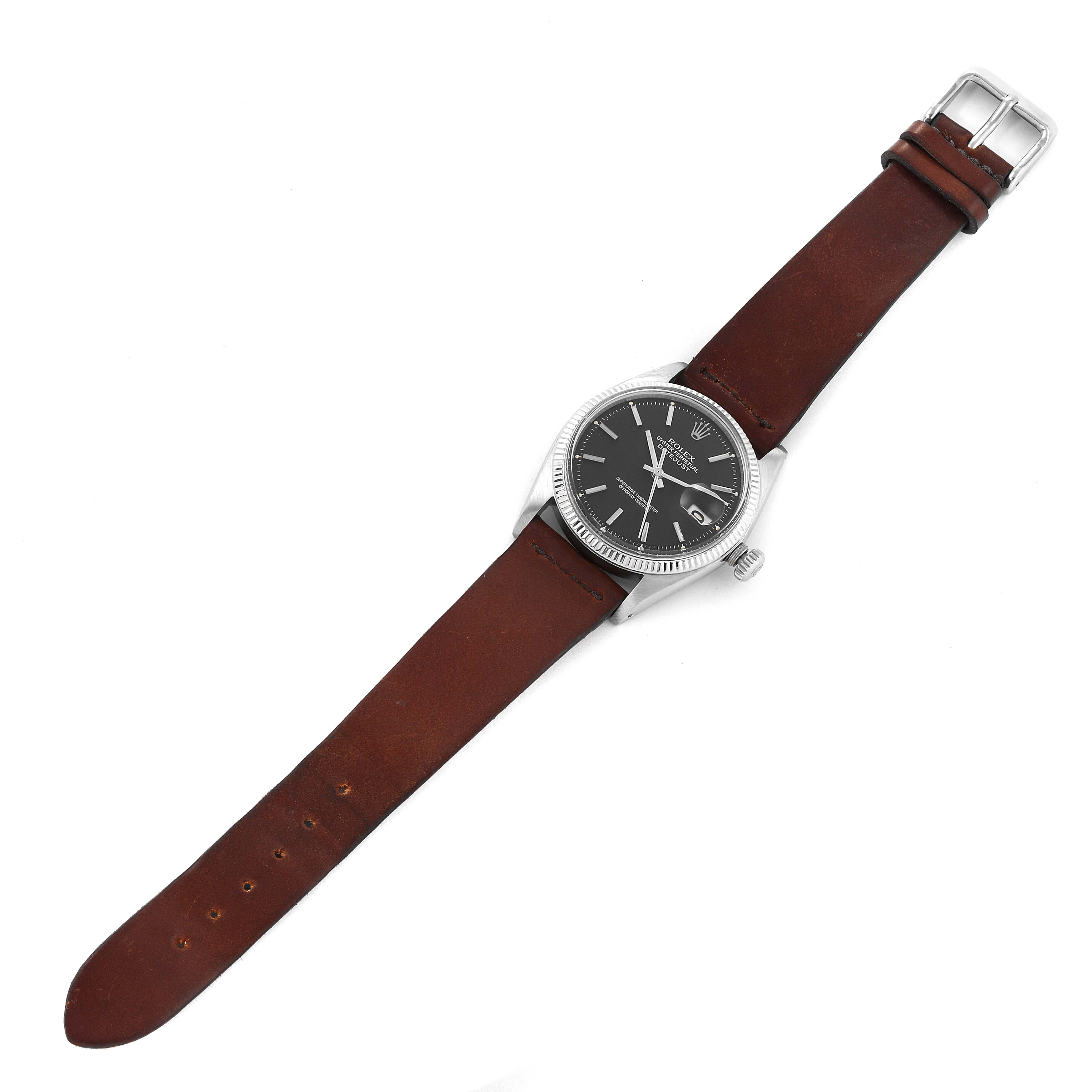 This Rolex Vintage Collection 1601 Men's Stainless Steel Black Dial 1601 Men's Stainless Steel Black Dial model watch is shown from a top-down angle, displaying its face, case, and brown leather strap.