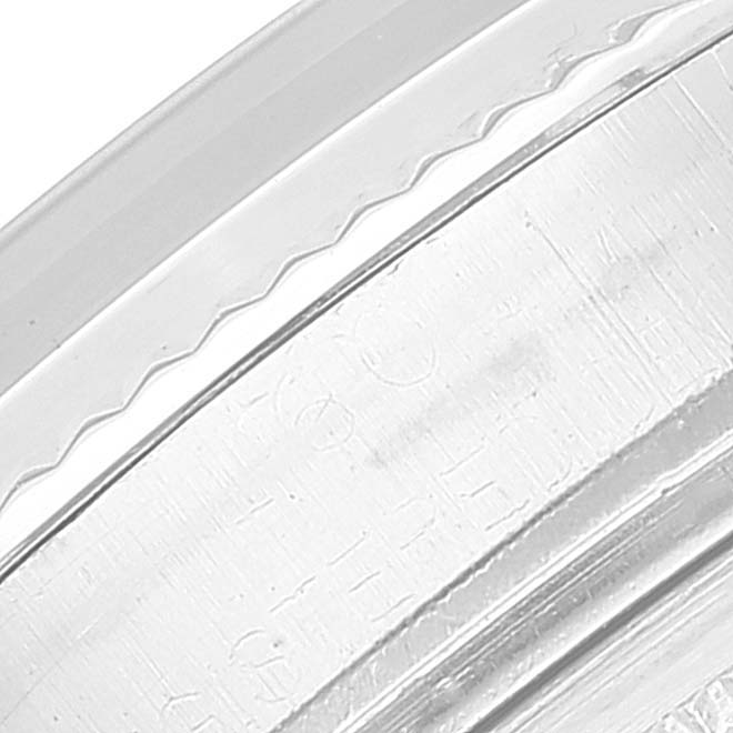 This image shows a close-up of the edge of the case back of a Rolex Vintage Collection 1601 Men's Stainless Steel Black Dial 1601 Men's Stainless Steel Black Dial watch.