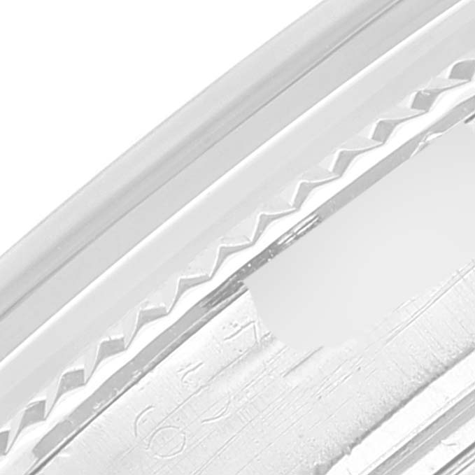 This close-up image shows part of the bezel and engravings on a Rolex Vintage Collection 1601 Men's Stainless Steel Black Dial 1601 Men's Stainless Steel Black Dial watch.