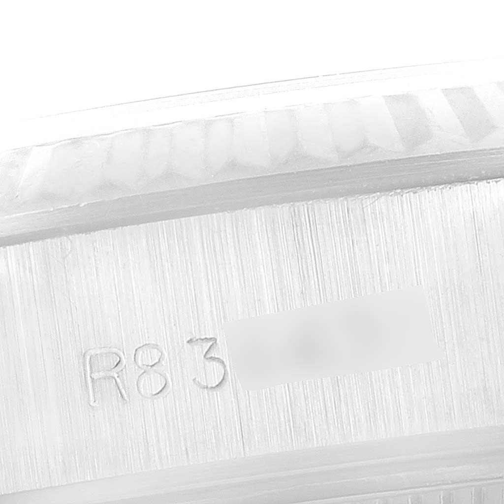 This is a close-up angle of the side of the Rolex Datejust 69174 Women's Stainless Steel Silver Dial 69174 Women's Stainless Steel Silver Dial showing part of the bezel and engraved serial number.