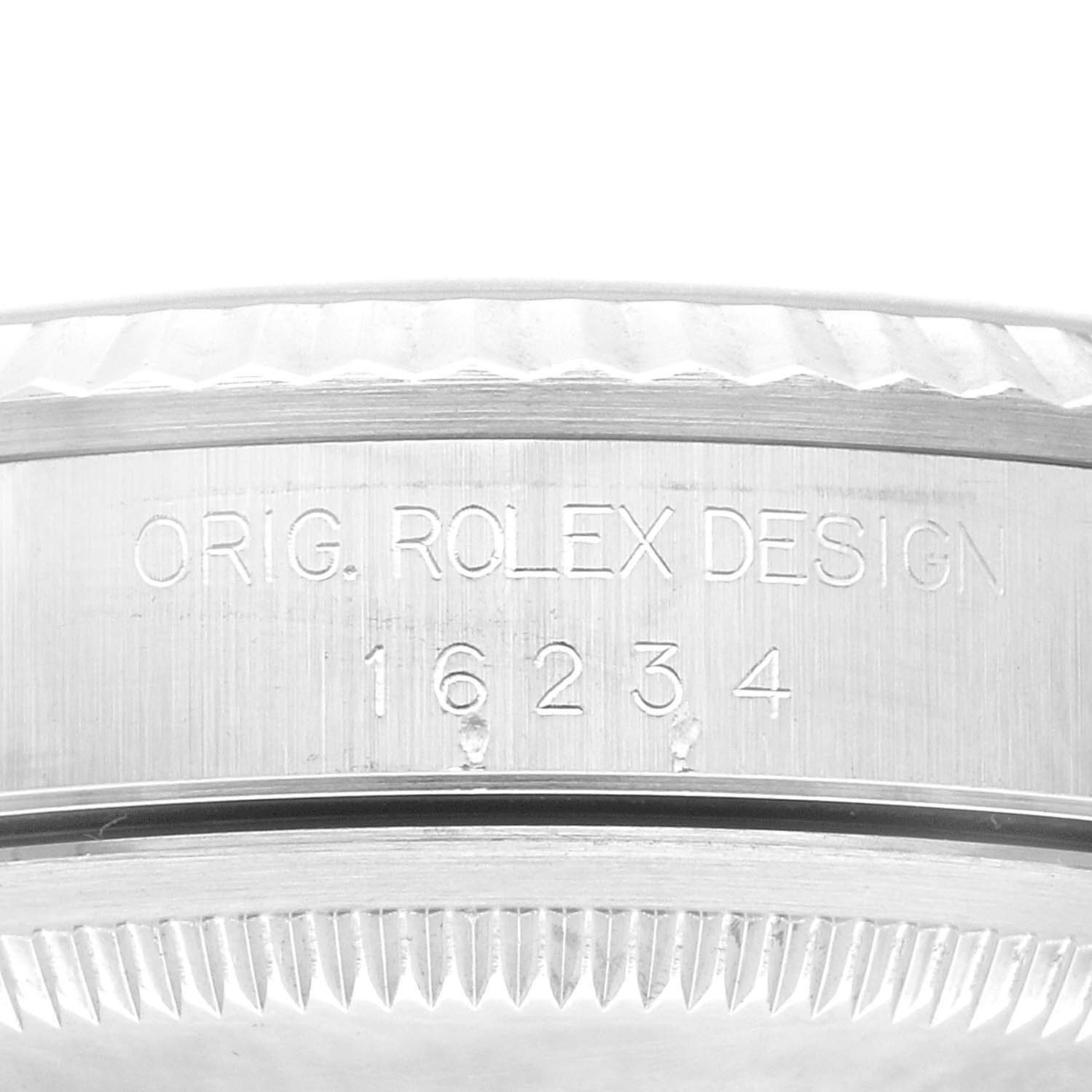 The image shows the side engraving on the case of the Rolex Datejust 16234 Men's Stainless Steel Pink Dial 16234 Men's Stainless Steel Pink Dial model, detailing "ORIG. ROLEX DESIGN 16234."