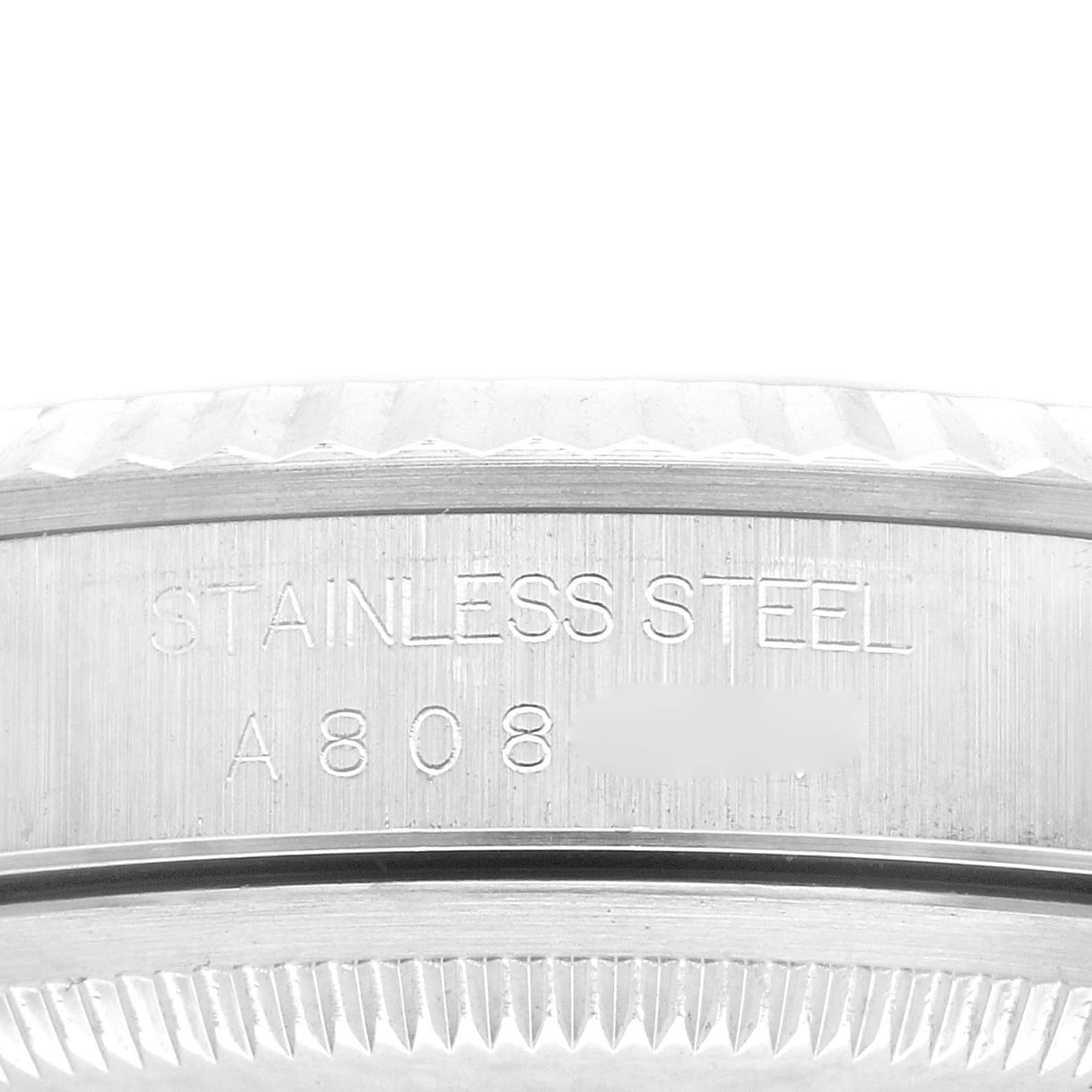 This image shows a side view of the Rolex Datejust 16234 Men's Stainless Steel Pink Dial 16234 Men's Stainless Steel Pink Dial watch, focusing on the edge of the bezel and case, with "STAINLESS STEEL" engraving.