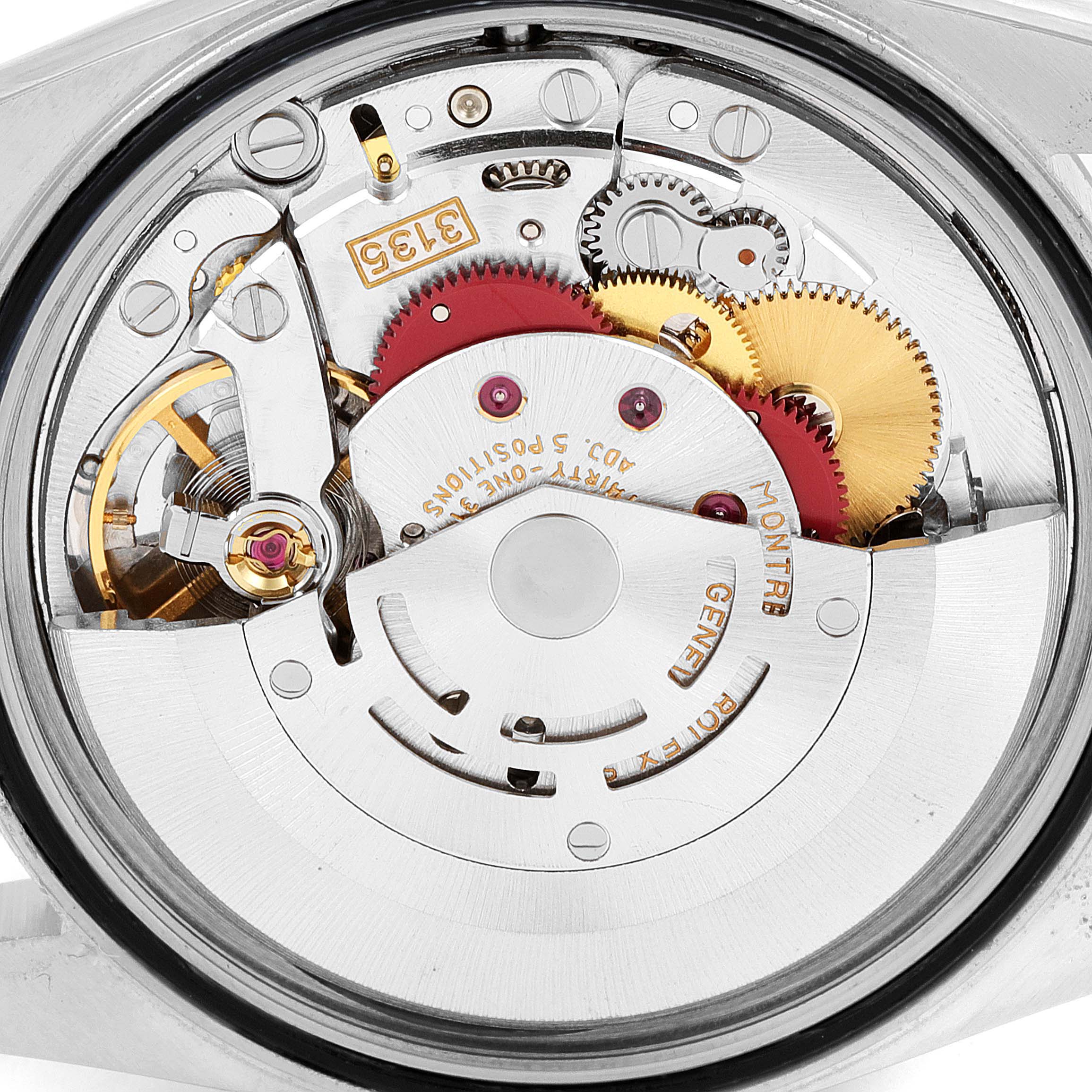 The image shows the internal mechanism of a Rolex Datejust 16233 Men
s Steel and Gold (two tone) Champagne Dial 16233 Men
s Steel and Gold (two tone) Champagne Dial watch from a back case angle, highlighting gears and the movement.