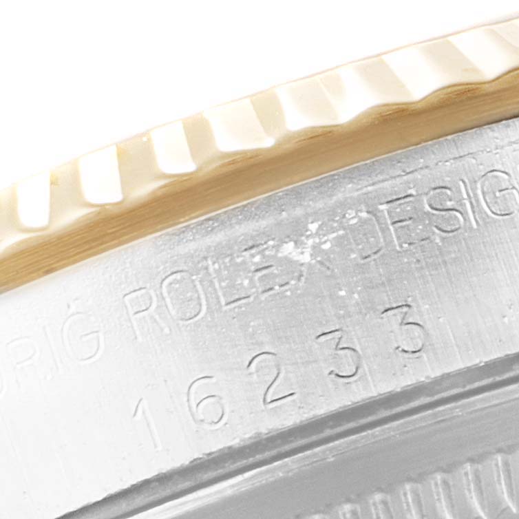 This image shows a close-up of the engraved bezel and case side of a Rolex Datejust 16233 Men
s Steel and Gold (two tone) Champagne Dial 16233 Men
s Steel and Gold (two tone) Champagne Dial watch.