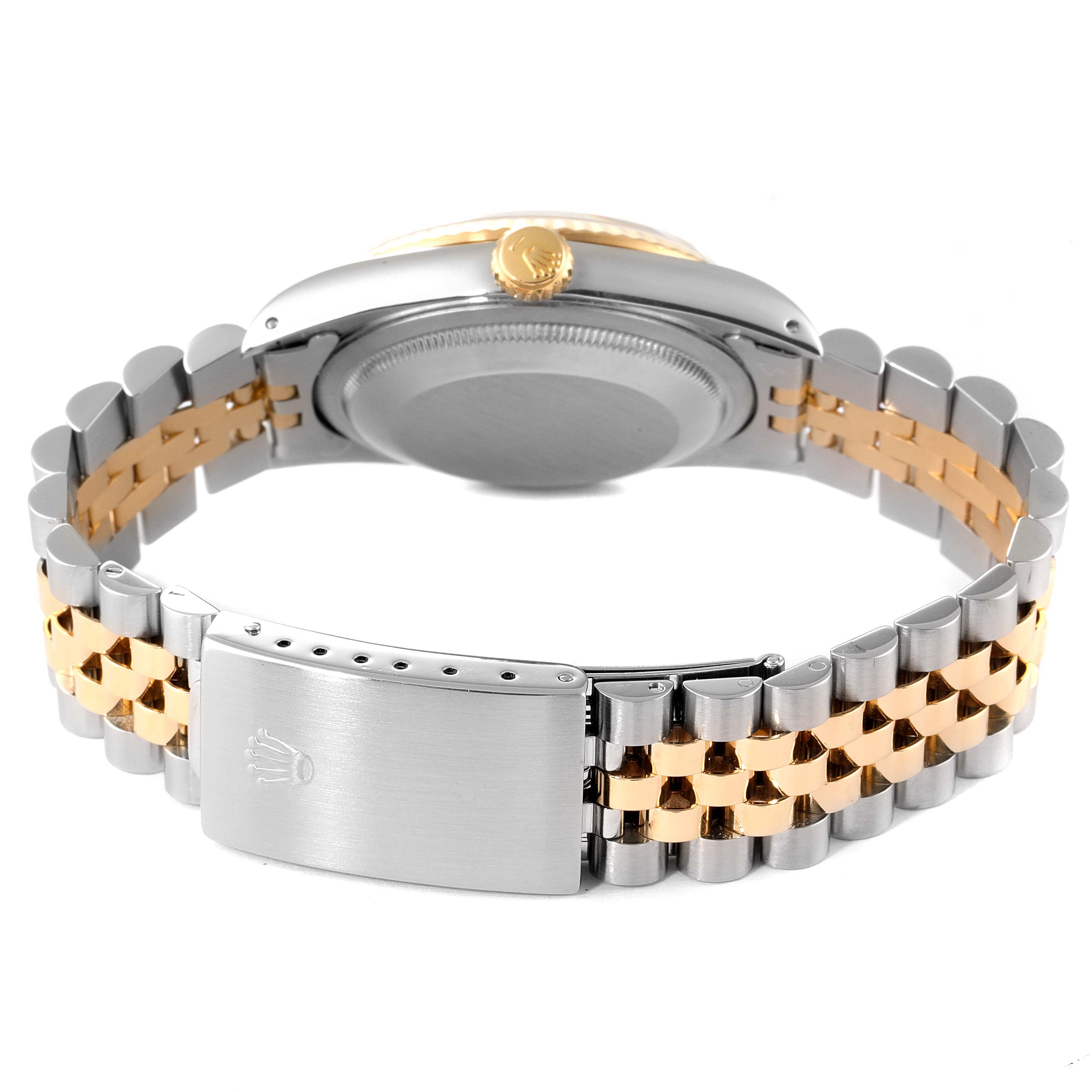 The image shows the back view of a Rolex Datejust 16233 Men
s Steel and Gold (two tone) Champagne Dial 16233 Men
s Steel and Gold (two tone) Champagne Dial watch, highlighting its bracelet, clasp, and case back.