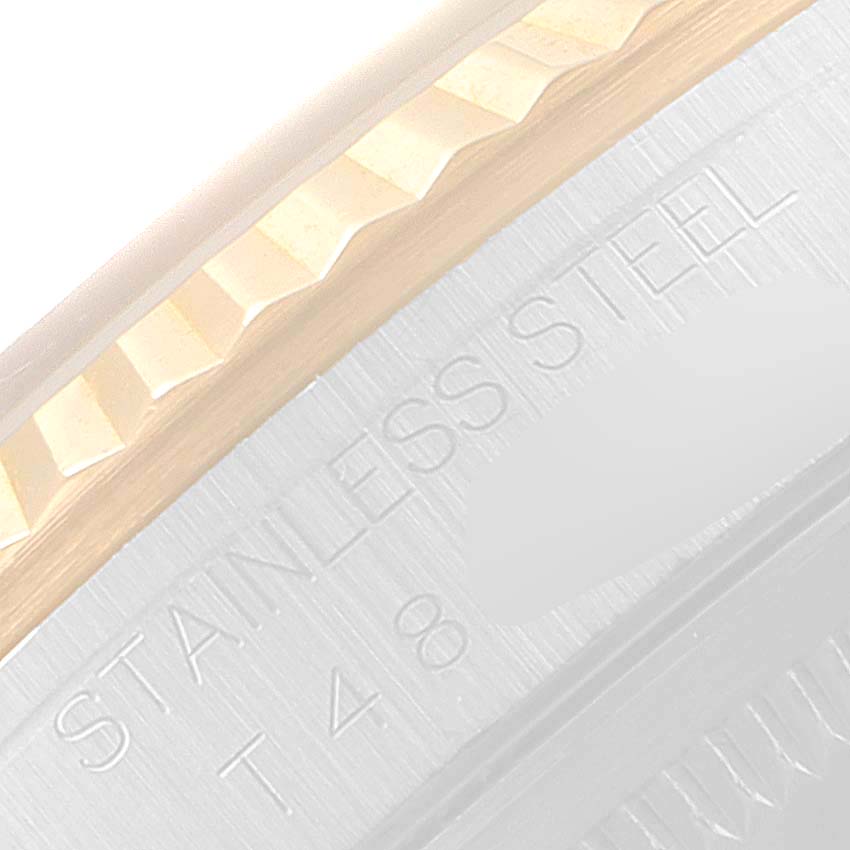 The image shows a close-up of the bezel and the engraved text on the stainless steel case of a Rolex Datejust 16233 Men's Steel and Gold (two tone) Champagne Dial 16233 Men's Steel and Gold (two tone) Champagne Dial watch.