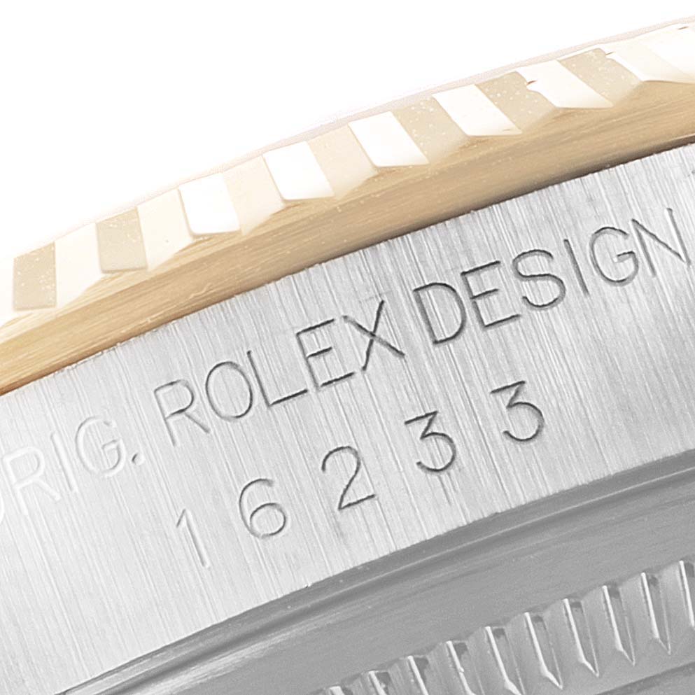 This close-up angle shows the engraved model number and fluted bezel of the Rolex Datejust 16233 Men's Steel and Gold (two tone) Champagne Dial 16233 Men's Steel and Gold (two tone) Champagne Dial watch.