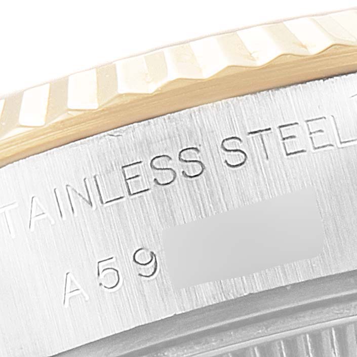 The image shows a close-up of the case back and engraved text of a Rolex Datejust 79173 Women
s Steel and Gold (two tone) Mother of Pearl Dial 79173 Women
s Steel and Gold (two tone) Mother of Pearl Dial watch, highlighting the stainless steel material and part of the serial number.