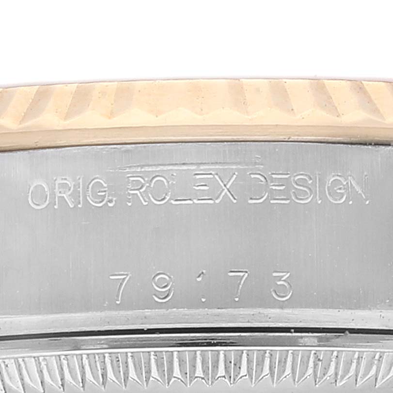 The image shows a close-up of the Rolex Datejust 79173 Women's Steel and Gold (two tone) Silver Dial 79173 Women's Steel and Gold (two tone) Silver Dial's case and serial number engraving.