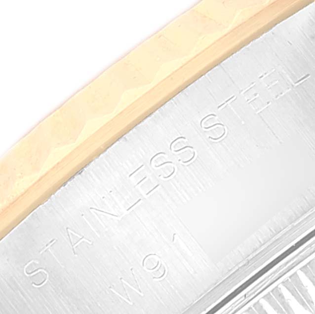 This close-up image shows the stainless steel case back edge and part of the fluted bezel of a Rolex Datejust 69173 Women's Steel and Gold (two tone) Blue Dial 69173 Women's Steel and Gold (two tone) Blue Dial watch.