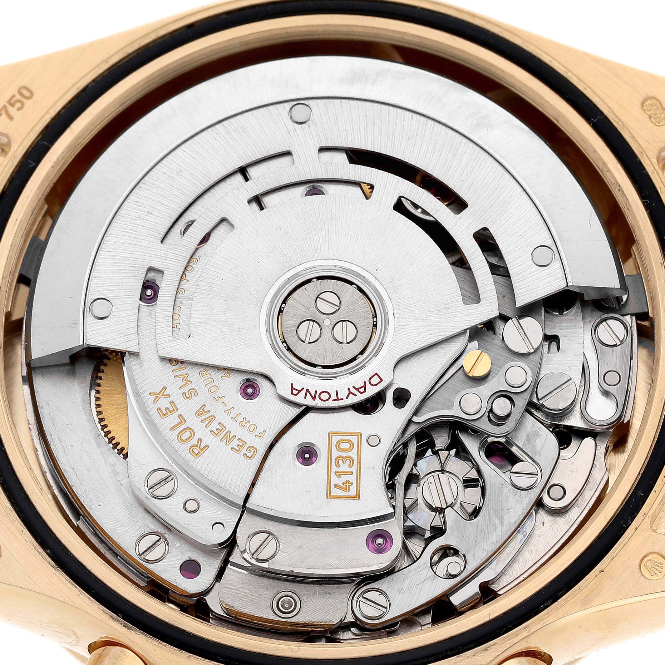 The image shows the back view of a Rolex Daytona 116528 Men's Yellow Gold White Dial, revealing its intricate movement and rotor.