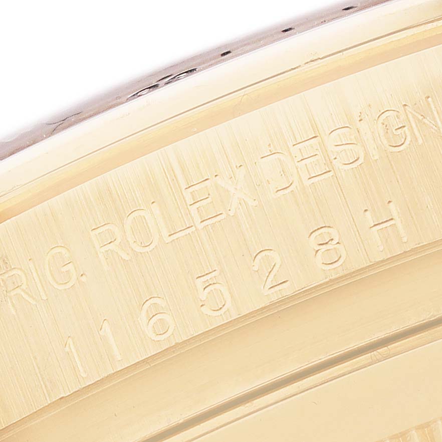 The image shows a close-up of the model number engraving on the side of the Rolex Daytona 116528 Men's Yellow Gold White Dial case.