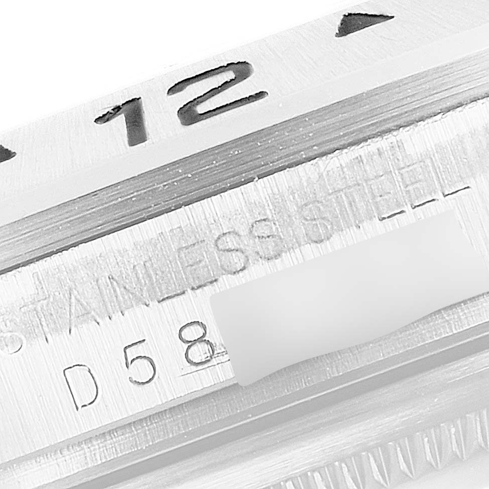 This close-up image shows the bezel and engraved serial number on a Rolex Explorer 16570 Men's Stainless Steel Black Dial 16570 Men's Stainless Steel Black Dial model watch.