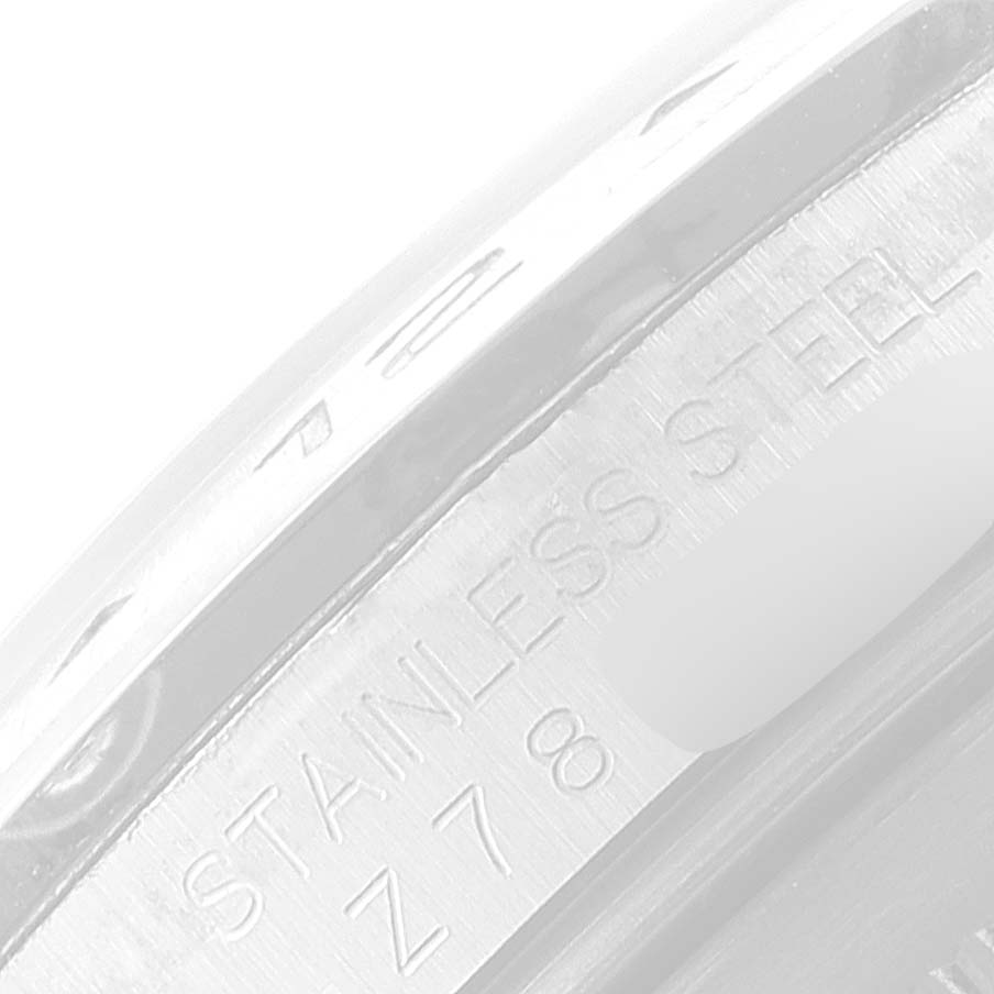 This image shows a close-up of the inner engraving of a Rolex Explorer 16570 Men
s Stainless Steel Black Dial 16570 Men
s Stainless Steel Black Dial watch, highlighting the "STAINLESS STEEL" inscription.